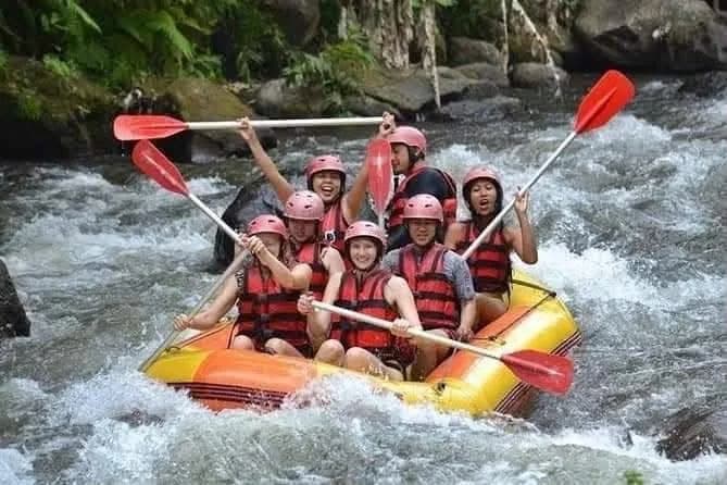 A group paddling through white water on a Bali river