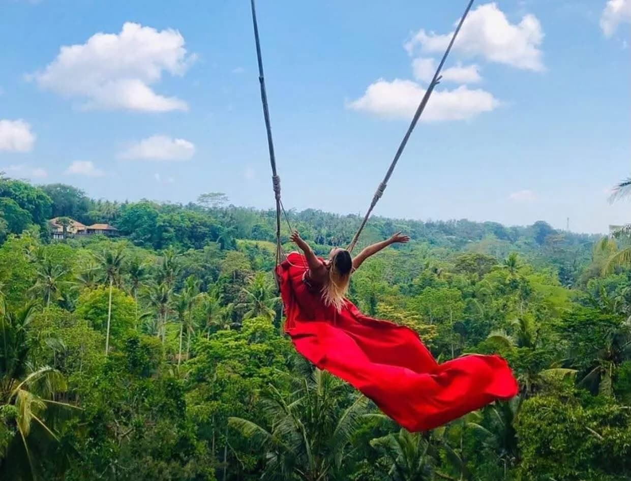 A guest swinging out over the jungle canopy near Ubud
