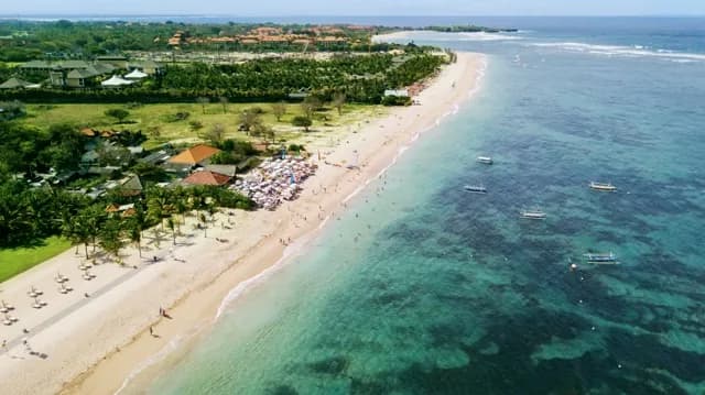 Tourists enjoying a holiday at Nusa Dua beach
